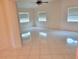 Bright bedroom featuring tile flooring, ceiling fan and plenty of natural light from three windows at 13725 Bermuda Dr, Seminole, FL 33776