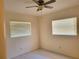 Cozy bedroom features neutral walls, modern tile flooring, and natural light through window blinds at 13725 Bermuda Dr, Seminole, FL 33776