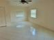 Bright bedroom featuring tile flooring, ceiling fan and plenty of natural light from two windows at 13725 Bermuda Dr, Seminole, FL 33776
