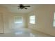 Bright bedroom featuring tile flooring, ceiling fan and plenty of natural light from two windows at 13725 Bermuda Dr, Seminole, FL 33776