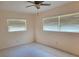 Minimalist bedroom with neutral walls, tile flooring, and natural light filtering through the window blinds at 13725 Bermuda Dr, Seminole, FL 33776