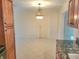 Light-filled dining room with tile floors and modern lighting fixtures at 13725 Bermuda Dr, Seminole, FL 33776