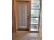 Well-lit doorway with unique glass-paneled features, showcasing bright natural light and tile flooring at 13725 Bermuda Dr, Seminole, FL 33776