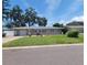Charming single-story home featuring a well-manicured lawn, a cozy outdoor dining area, and an attached garage at 13725 Bermuda Dr, Seminole, FL 33776