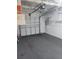 Spacious garage with automatic door opener and attached shelving units for plenty of storage at 13725 Bermuda Dr, Seminole, FL 33776
