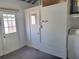 Laundry room with doors to outside and white appliances, including washer and dryer at 13725 Bermuda Dr, Seminole, FL 33776