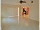 Spacious living room with tile flooring leading to a glimpse of the kitchen, showcasing an open layout at 13725 Bermuda Dr, Seminole, FL 33776