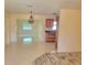 Open living area with modern lighting, tile floors, and easy access to the kitchen at 13725 Bermuda Dr, Seminole, FL 33776