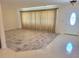 Inviting living room with wood-style tile, featuring a decorative front door and adjacent tiled entrance at 13725 Bermuda Dr, Seminole, FL 33776