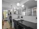Bathroom featuring a large mirror, vanity, and tiled shower with glass door at 1382 52Nd Ne Ave, St Petersburg, FL 33703