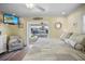 Bedroom with TV and patio doors leading to canal-side deck with seating and water views at 1382 52Nd Ne Ave, St Petersburg, FL 33703