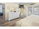 Bedroom with white dresser, chair, mounted TV, and patio access to canal side deck at 1382 52Nd Ne Ave, St Petersburg, FL 33703