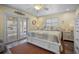 Bright bedroom with a decorative quilt, ceiling fan, and access to outdoor deck with canal view at 1382 52Nd Ne Ave, St Petersburg, FL 33703