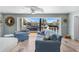 Living room features sliding glass doors to the canal-front deck with comfortable seating at 1382 52Nd Ne Ave, St Petersburg, FL 33703