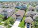 Aerial view of a home with lush landscaping, driveway, and a neatly maintained lawn at 13912 Painted Bunting Ln, Riverview, FL 33579