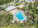 Aerial view of community pool and amenities featuring a basketball court, playground, and picnic area at 13912 Painted Bunting Ln, Riverview, FL 33579
