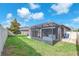 Fenced backyard featuring a screened patio area and a well-maintained lawn at 13912 Painted Bunting Ln, Riverview, FL 33579