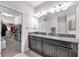 Bathroom featuring a double vanity with granite countertop and a walk-in closet at 13912 Painted Bunting Ln, Riverview, FL 33579