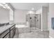 Bright bathroom showcasing a soaking tub and separate glass shower, complemented by neutral tile flooring at 13912 Painted Bunting Ln, Riverview, FL 33579