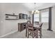 Dining room featuring a dark wood dining table with decorative lighting and floating shelves at 13912 Painted Bunting Ln, Riverview, FL 33579