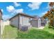 Well-maintained exterior featuring a shed, screened-in patio, and air conditioning unit at 13912 Painted Bunting Ln, Riverview, FL 33579