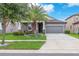 Inviting home boasts a well-manicured lawn, beautiful landscaping, and a cozy front porch at 13912 Painted Bunting Ln, Riverview, FL 33579