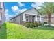 Attractive one-story home with manicured lawn, lush landscaping, and a welcoming front porch at 13912 Painted Bunting Ln, Riverview, FL 33579