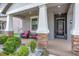 Cozy front porch with brick-covered columns provides a relaxing outdoor seating area at 13912 Painted Bunting Ln, Riverview, FL 33579