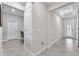 Neutral hallway boasts tile floors, natural light, and easy access to the rest of the home at 13912 Painted Bunting Ln, Riverview, FL 33579