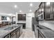 Spacious kitchen with dark cabinets, stainless steel appliances, granite countertops, and white backsplash at 13912 Painted Bunting Ln, Riverview, FL 33579