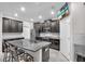Modern kitchen with granite counters, stainless appliances, a tv and a large island with seating at 13912 Painted Bunting Ln, Riverview, FL 33579