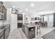 Open kitchen featuring granite countertops, stainless steel appliances, a kitchen island and dark wood cabinets at 13912 Painted Bunting Ln, Riverview, FL 33579