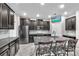 Modern kitchen featuring dark cabinets, stainless steel appliances and a large kitchen island with seating at 13912 Painted Bunting Ln, Riverview, FL 33579