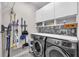 Well-organized laundry room with modern appliances and stylish marble backsplash at 13912 Painted Bunting Ln, Riverview, FL 33579