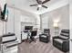 Functional office space includes built-in storage, a ceiling fan, and comfortable seating at 13912 Painted Bunting Ln, Riverview, FL 33579