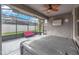 Relaxing screened patio with a hot tub, ceiling fan, and comfortable seating at 13912 Painted Bunting Ln, Riverview, FL 33579