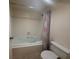 Bathroom with standard bathtub, shower, shower curtain, tile walls, toilet and grab bar at 14950 Gulf Blvd # 603, Madeira Beach, FL 33708
