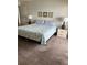 Cozy bedroom featuring a comfortable bed with beach themed decor and two nightstands at 14950 Gulf Blvd # 603, Madeira Beach, FL 33708