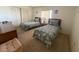 Bedroom with two twin beds, bureau, nightstand, lamp, and natural light from window at 14950 Gulf Blvd # 603, Madeira Beach, FL 33708