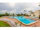Large community pool with ample seating, lush landscaping, and views of the ocean at 14950 Gulf Blvd # 603, Madeira Beach, FL 33708