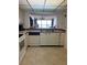 View of kitchen with white cabinets and stainless steel sink at 14950 Gulf Blvd # 603, Madeira Beach, FL 33708
