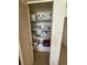 Linen closet with shelving filled with towels and blankets behind a paneled door at 14950 Gulf Blvd # 603, Madeira Beach, FL 33708