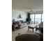 Well-lit living area with sofas, tables, and balcony access with ocean view at 14950 Gulf Blvd # 603, Madeira Beach, FL 33708