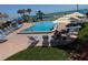 An outdoor pool with lounge chairs surrounded by manicured grass with beach access, a great spot for a relaxing vacation at 14950 Gulf Blvd # 603, Madeira Beach, FL 33708