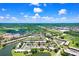 Aerial view of condo community, showcasing mature trees, a peaceful pond, and convenient parking at 172 Lakeview Way # 172, Oldsmar, FL 34677