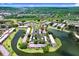 Aerial view of the condominium complex with lush landscaping, a lake, and organized parking at 172 Lakeview Way # 172, Oldsmar, FL 34677