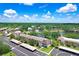 An aerial of the condo community highlighting a pond, mature trees, covered parking and a well-maintained landscape at 172 Lakeview Way # 172, Oldsmar, FL 34677