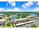 Beautiful aerial view of the condos showcasing the building, pond, mature landscaping, and covered parking at 172 Lakeview Way # 172, Oldsmar, FL 34677