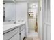 Bright bathroom featuring a white vanity and sink with a view into the shower with patterned shower curtain at 172 Lakeview Way # 172, Oldsmar, FL 34677