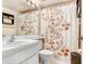 Bathroom with a white sink, toilet, and a floral shower curtain with decorative flower design at 172 Lakeview Way # 172, Oldsmar, FL 34677